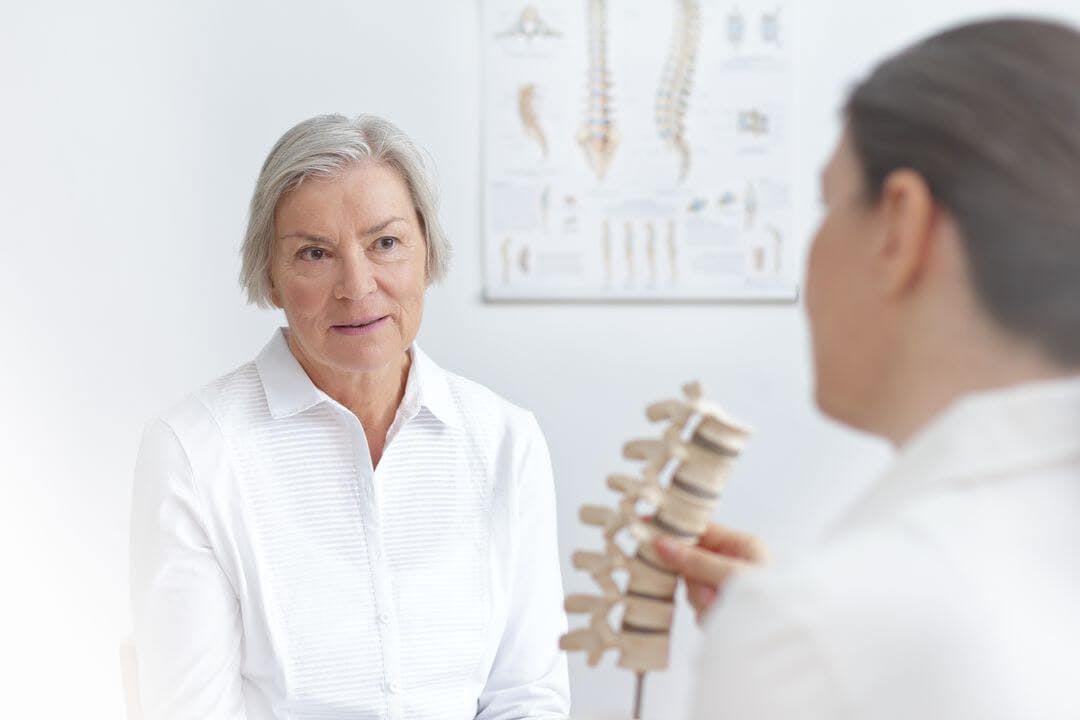 Osteoporosis doctor showing example of spine