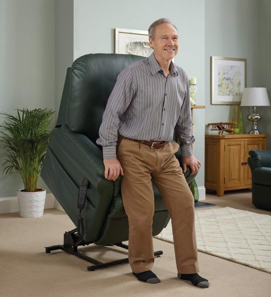 Elderly man rising out of a rise and recline chair.