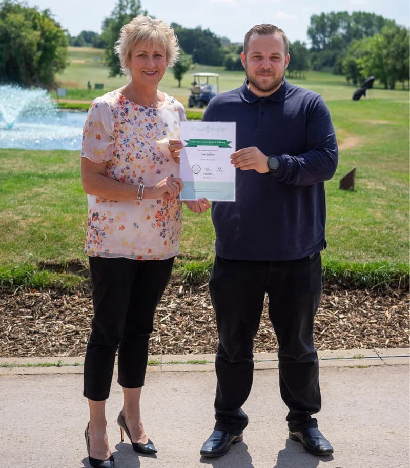 Sam Shann and representative holding certificate