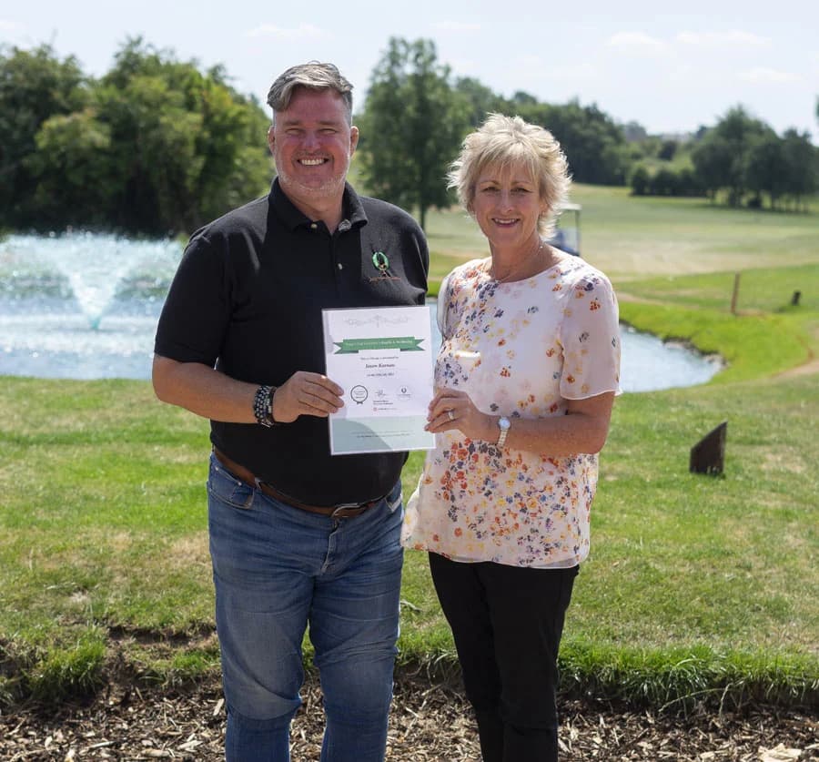 Sam Shann and representative holding certificate