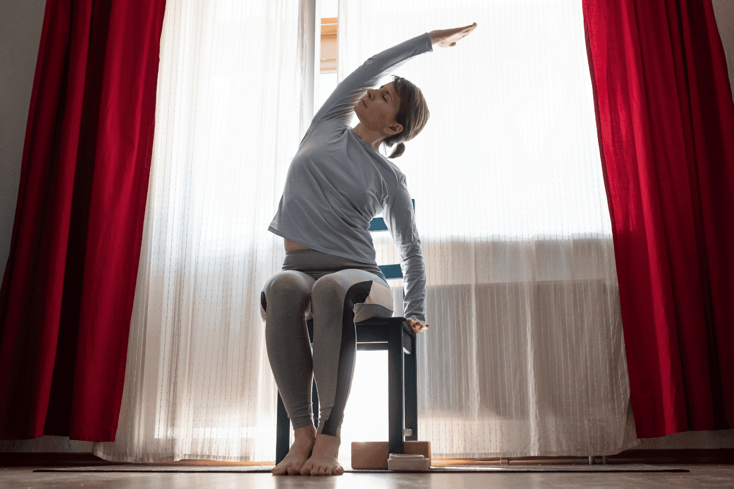 Woman doing yoga whilst seated.