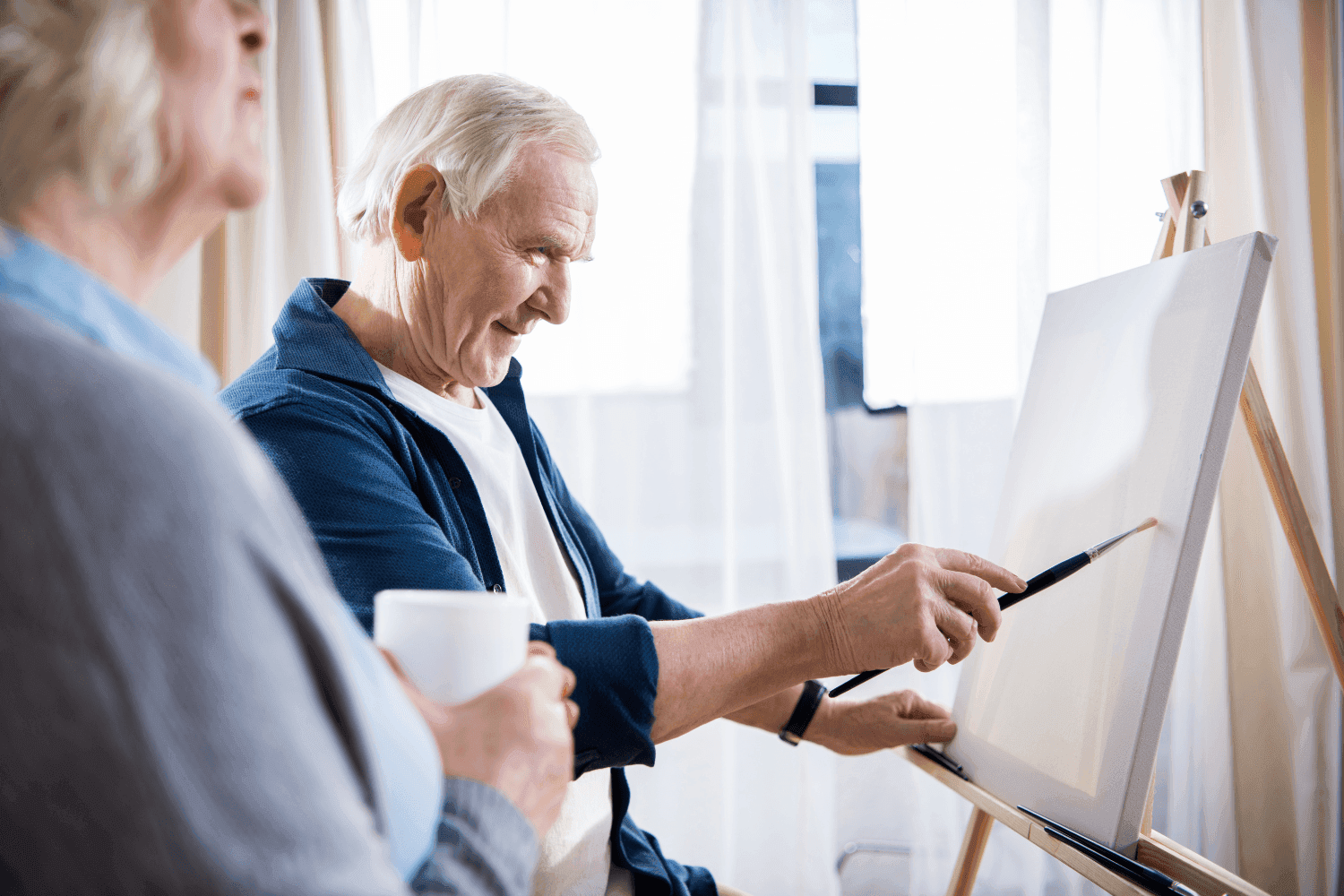 Image of man painting a canvas