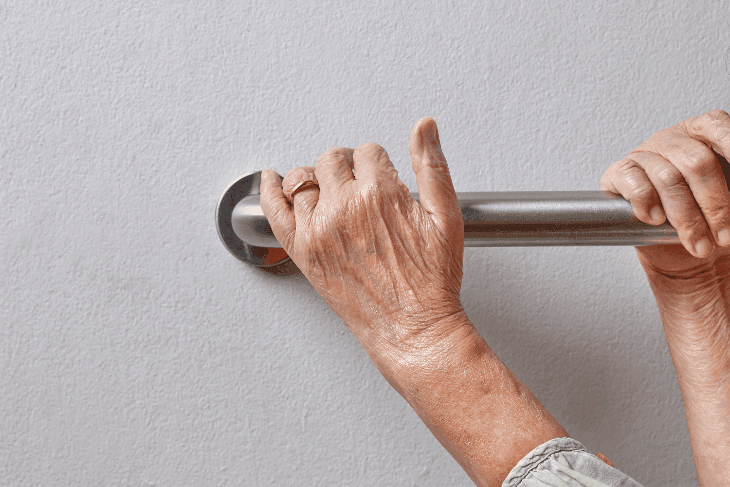 Person using grab rail to help lift themselves up