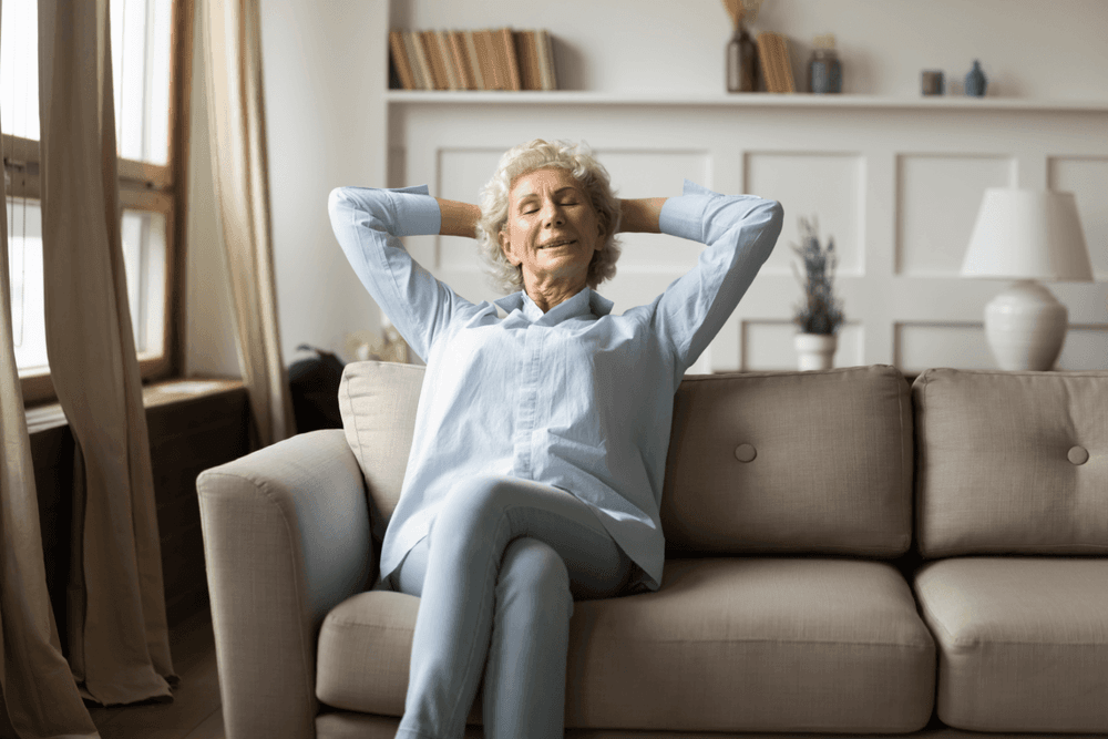 woman leaning back to take a nap on the sofa