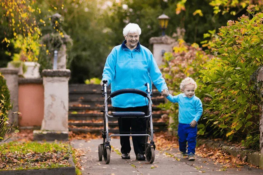 Lady with her zimmer frame and grandson