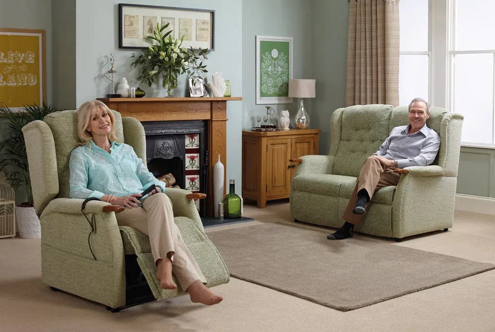 Couple sat in their Oak Tree rise and recline chair and sofa