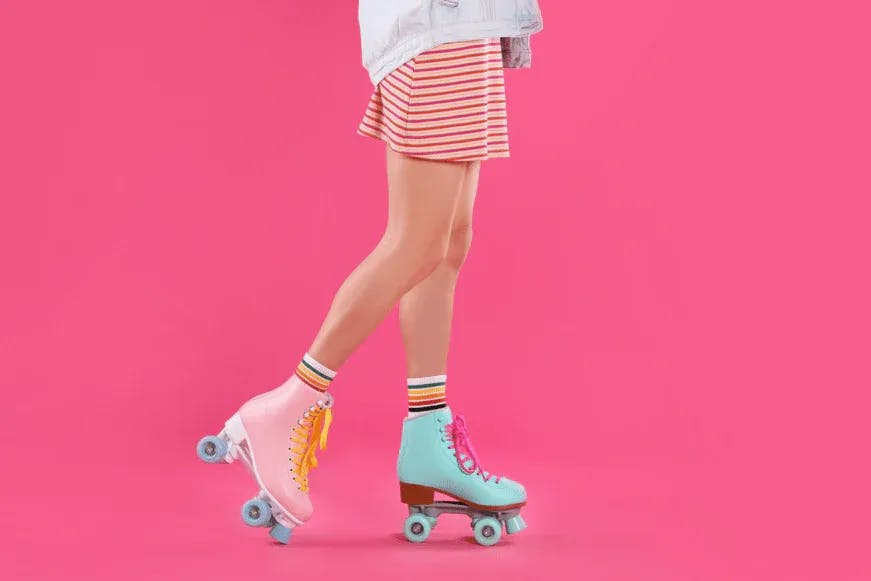 Rollerskating woman on a pink background