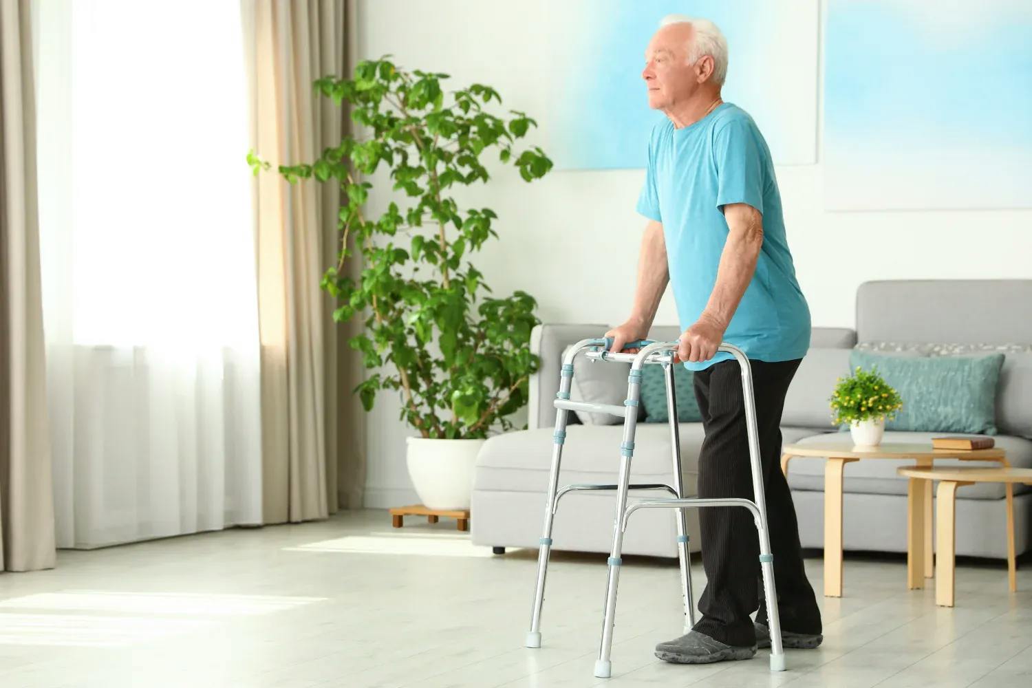 Man walking with walking aid without wheels inside the home