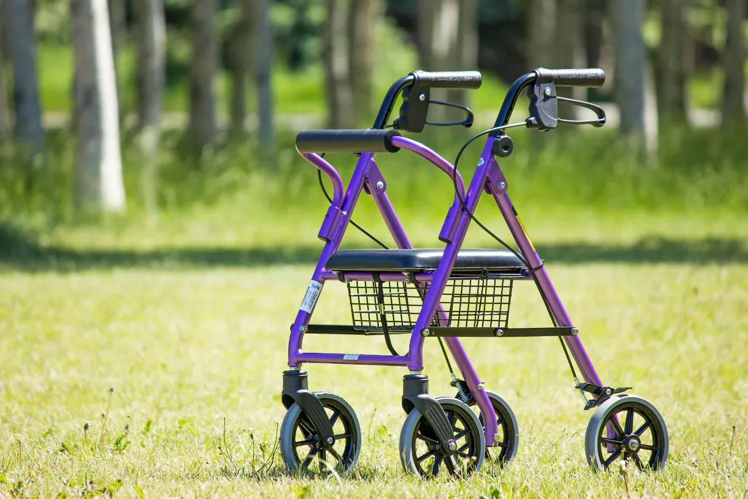 Walking aid with seat, rollator outside in the grass