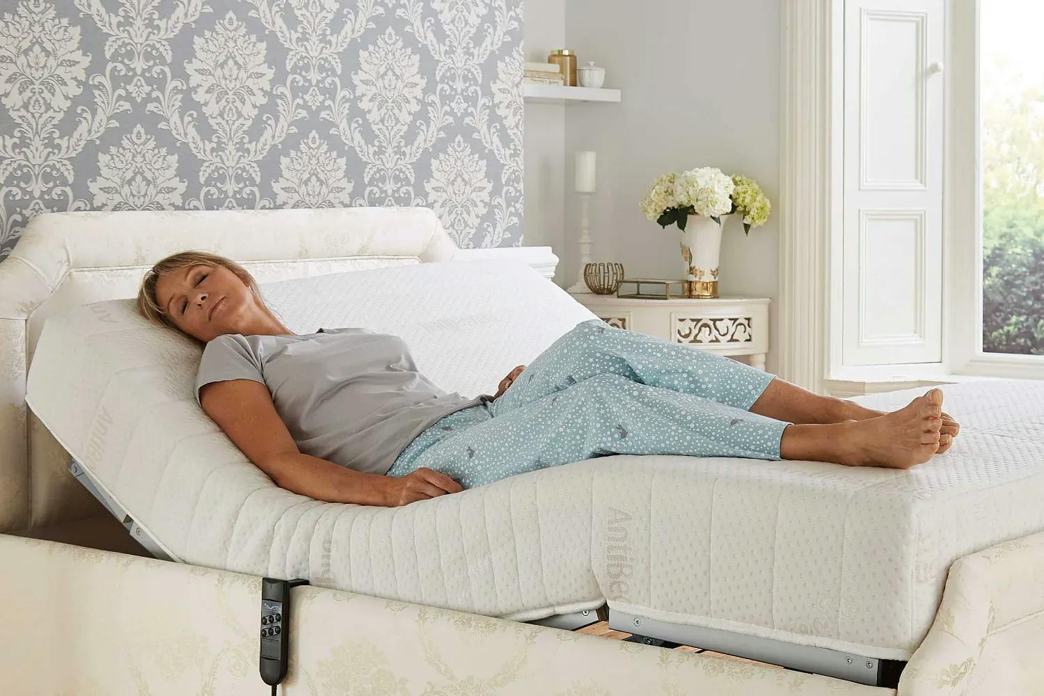Woman lying on an adjustable bed