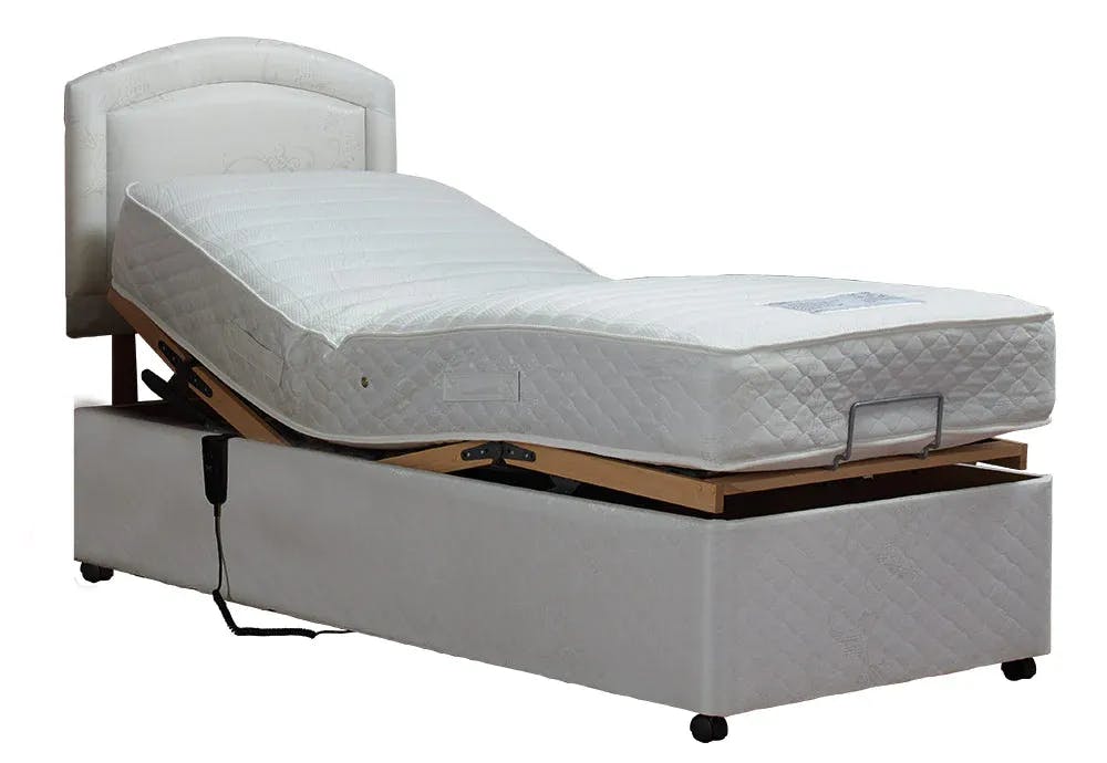 This image shows a single bed that has slightly reclined and a control on the side of the bed where you can adjust the settings of the bed.