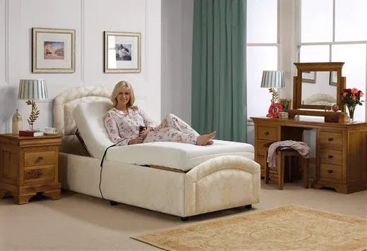 Woman sitting on a single adjustable reclining bed