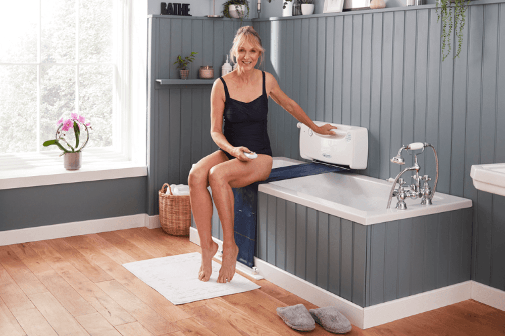 Lady sat on edge of bath about to use an Oak Tree bath lift