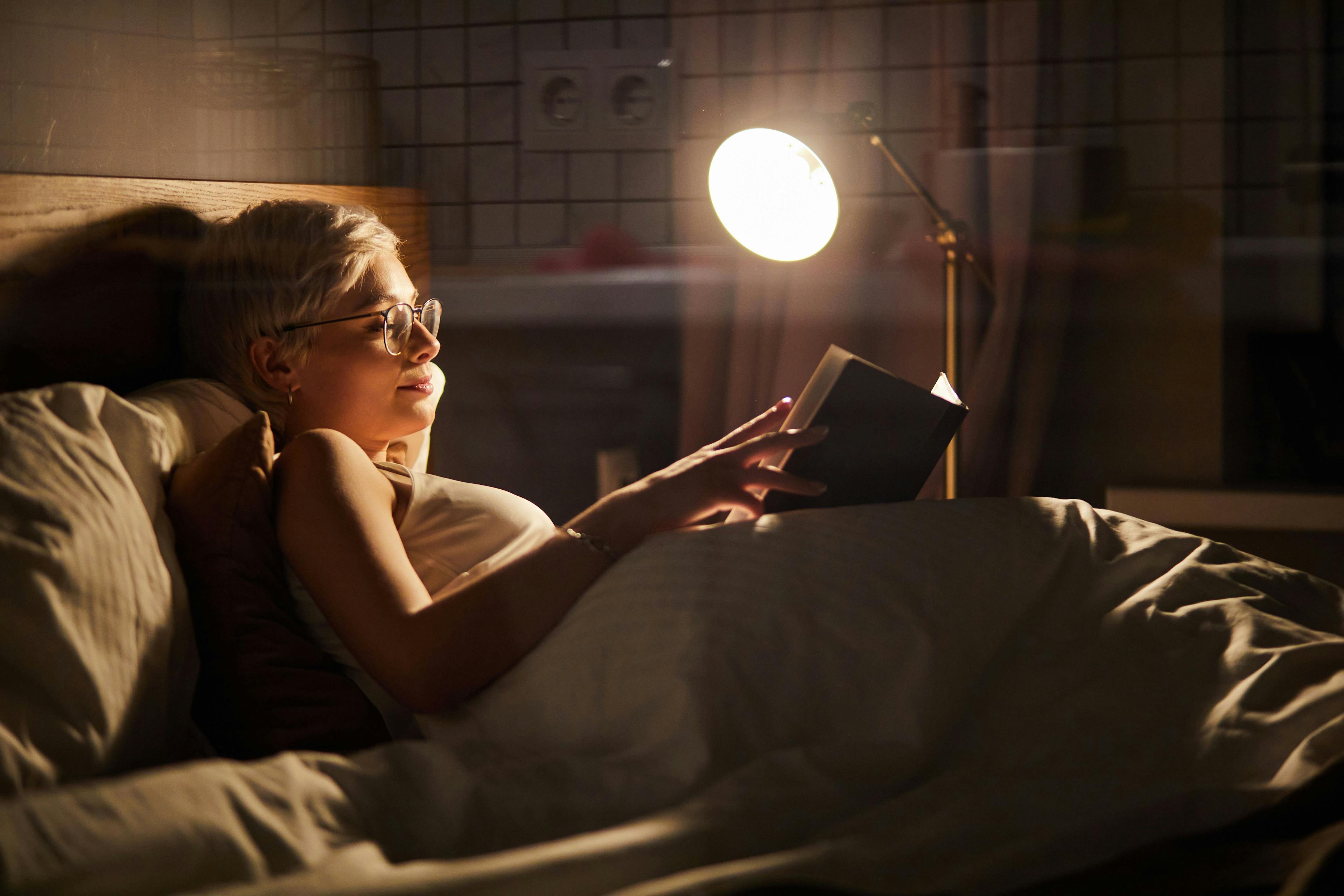Image of woman reading in bed