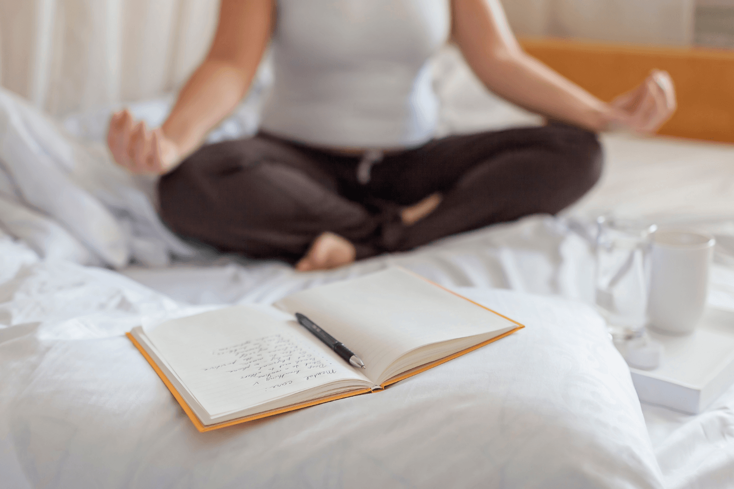 Woman meditating and Journaling in bed