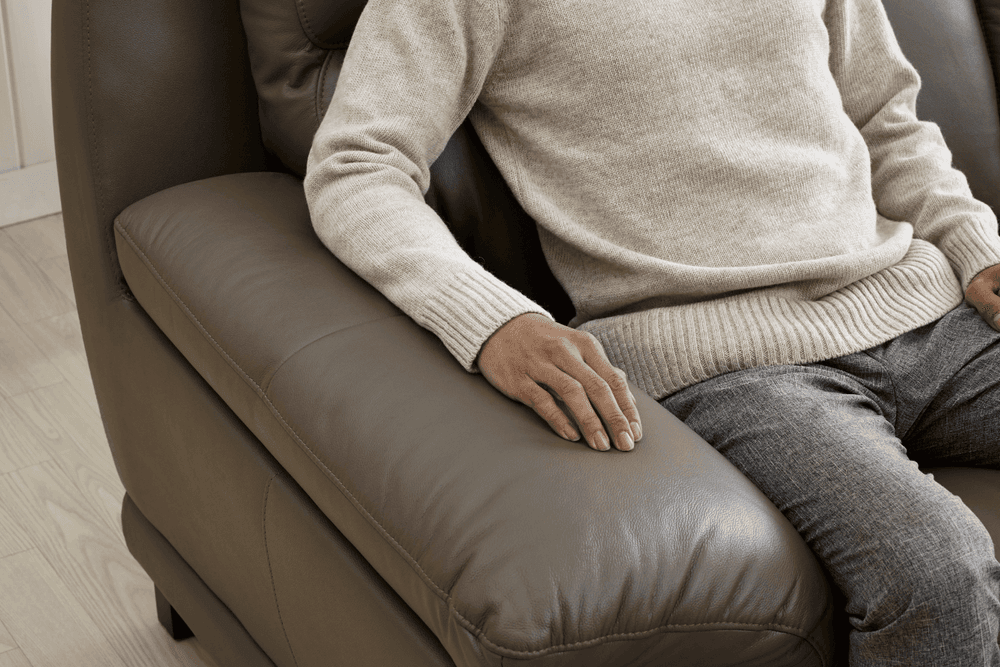 image of man in a leather manual recliner