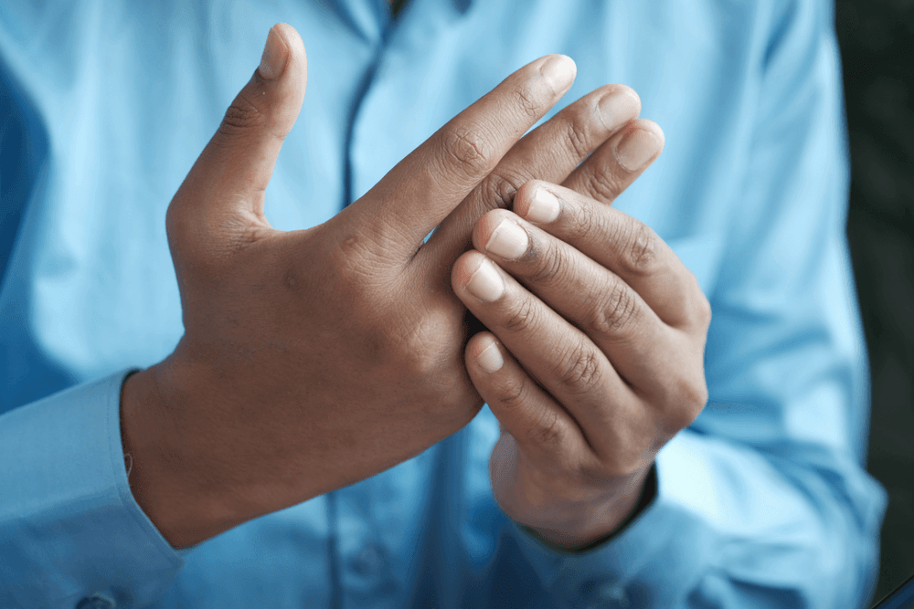 Image of man feeling bones in fingers