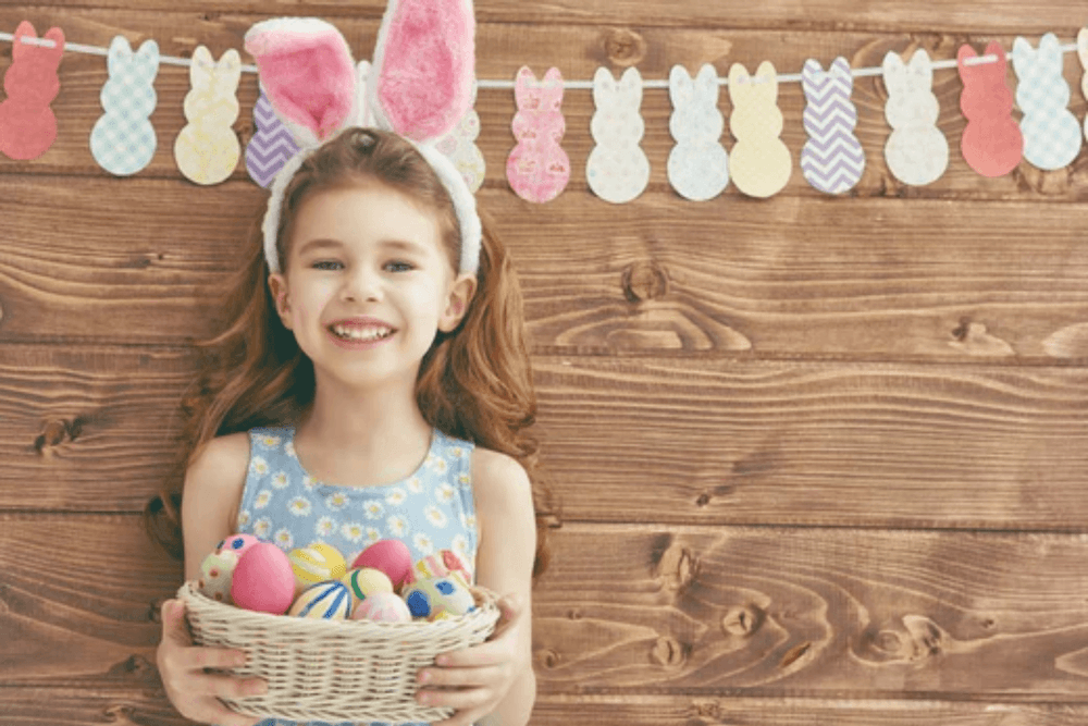 Young girl holding easter egg basket
