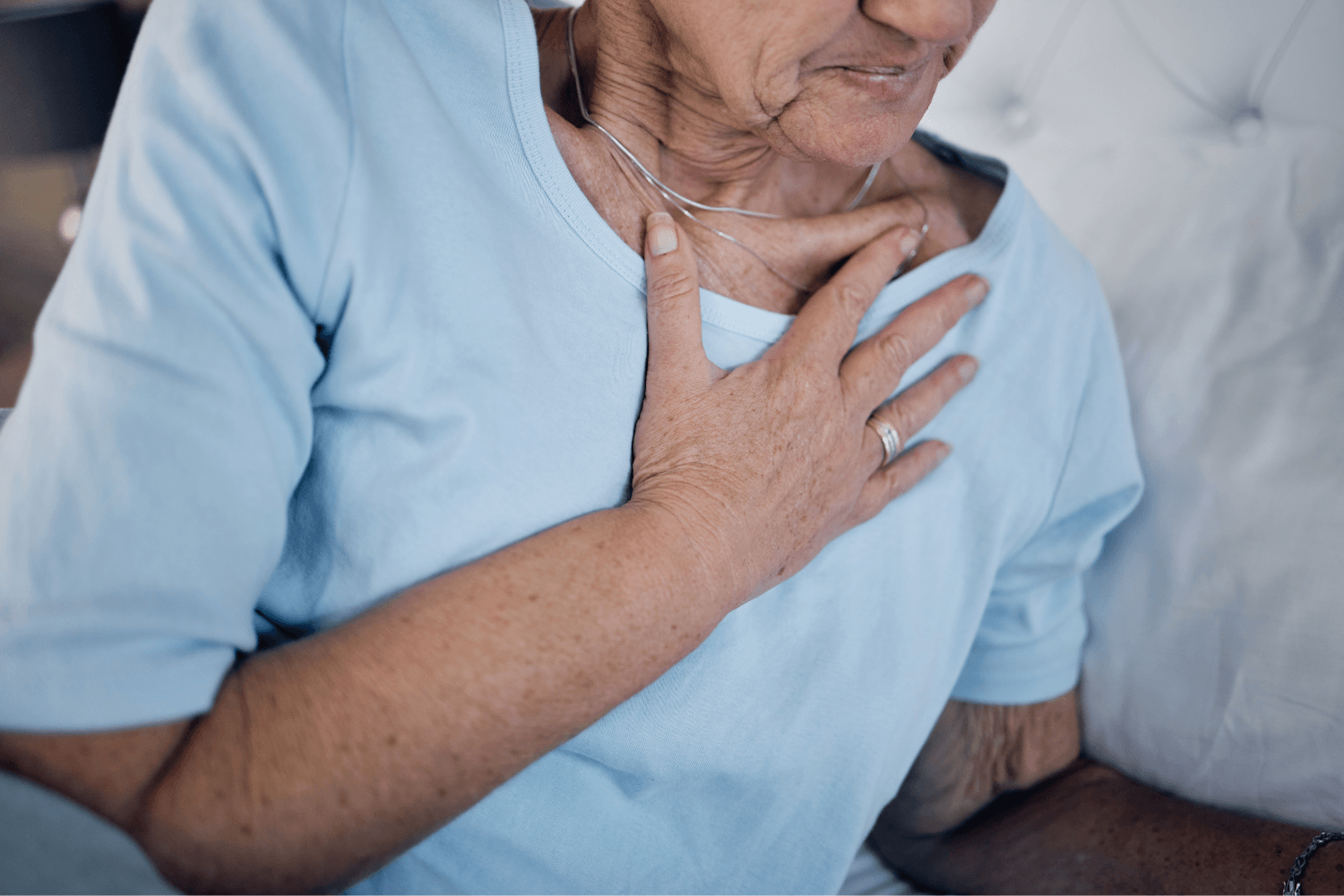 Woman touching chest due to heartburn