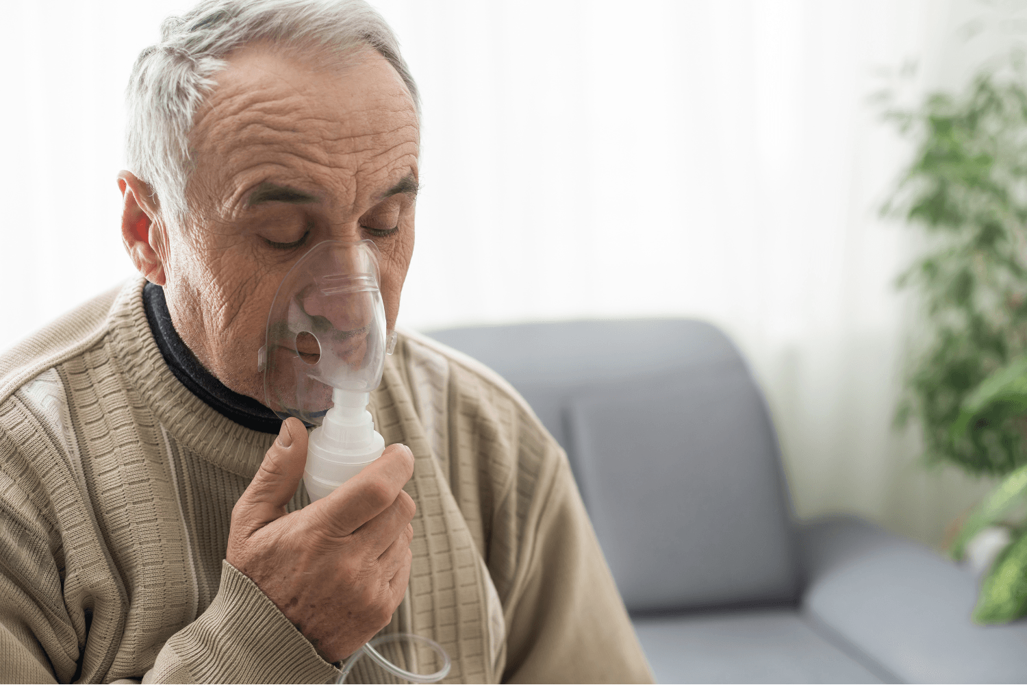 Man using inhaler to breath