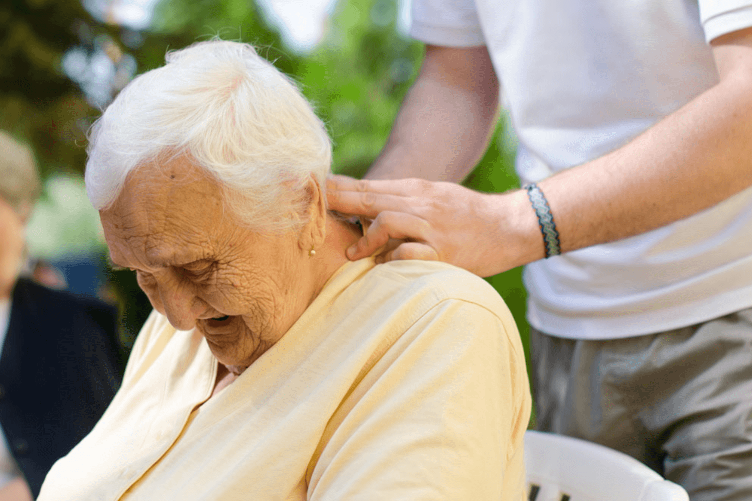 Elderly lady receiving back massage