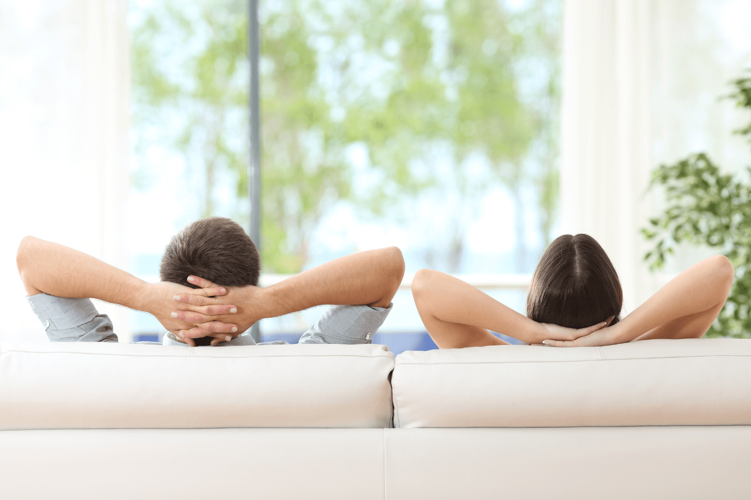 Couple relaxing on a 2-seater sofa