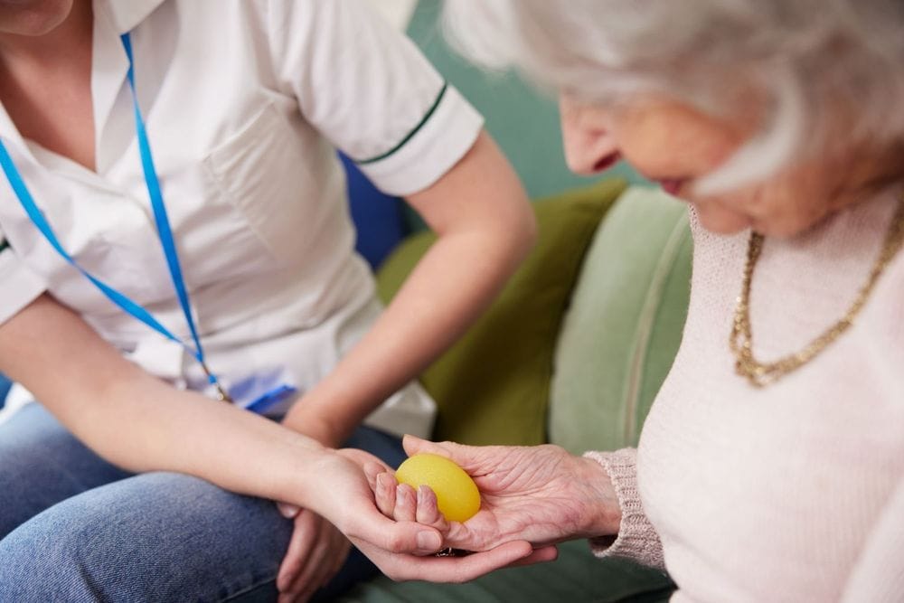 Elderly lady holding assistive product