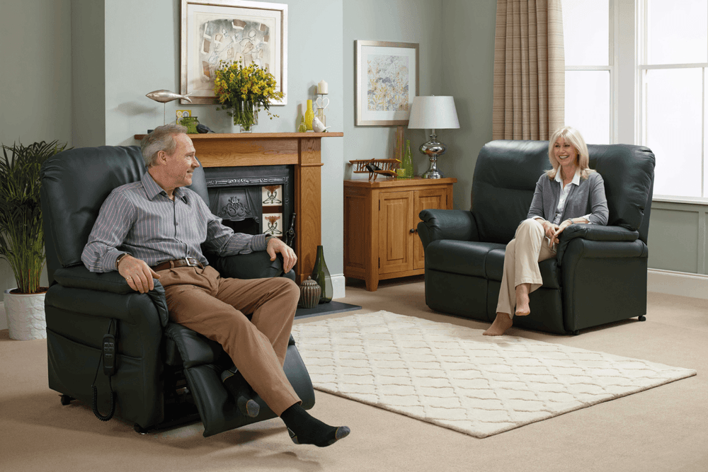 Two people sit on a recliner chair in a reclining position