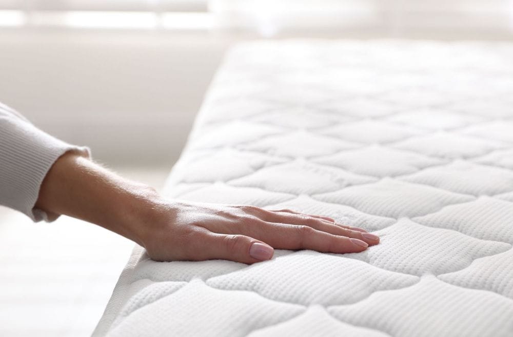 Hand on mattress