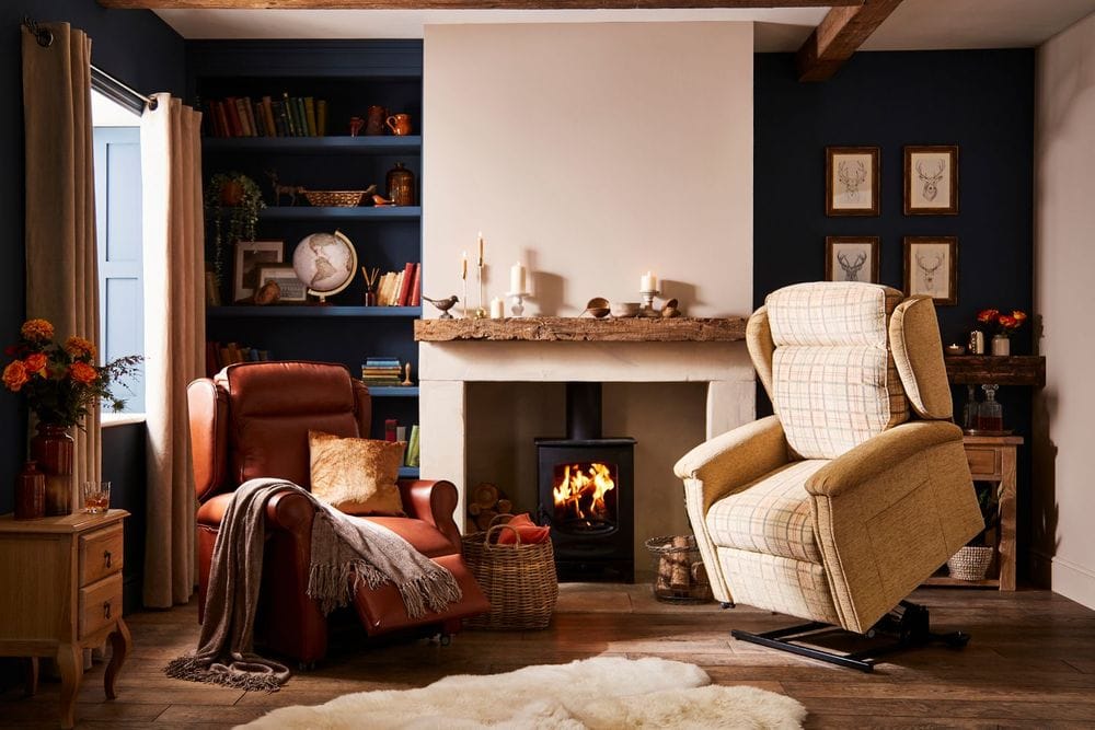Two Parker Knoll chairs, one fabric full raise, one leather foot propped