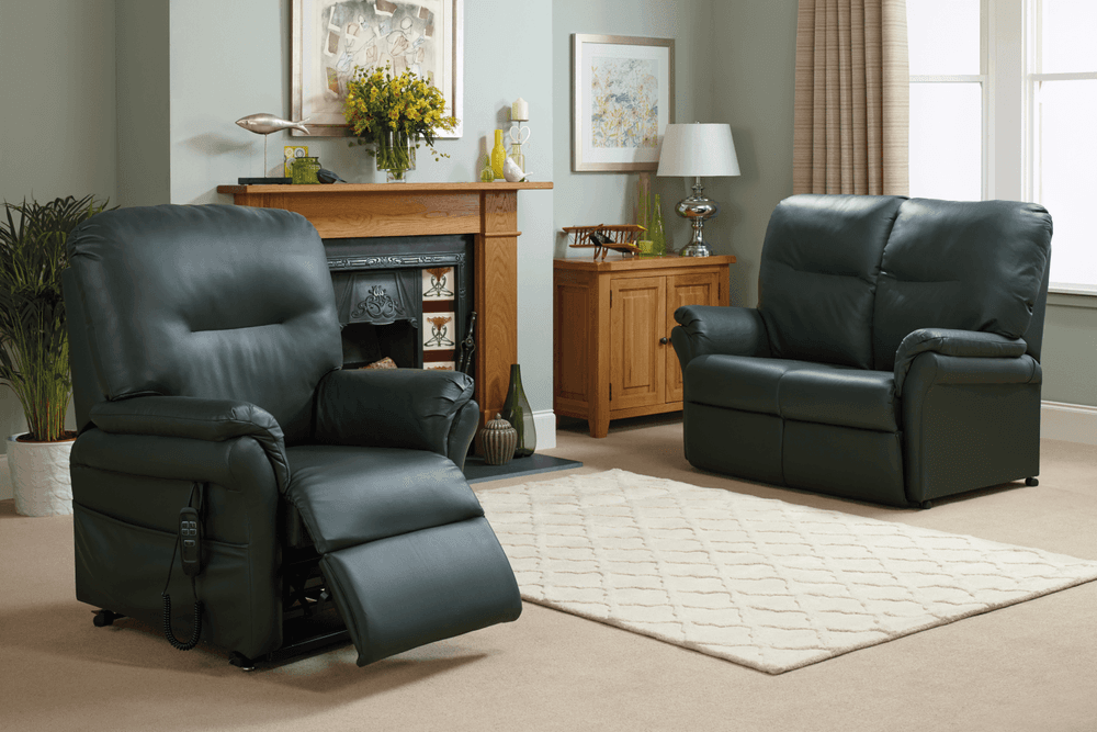 Black leather maple recliner chair and black leather maple recliner sofa beside a fireplace